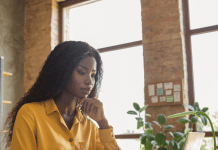 Five Ways to Invest in Yourself Black woman investing in herself by reading